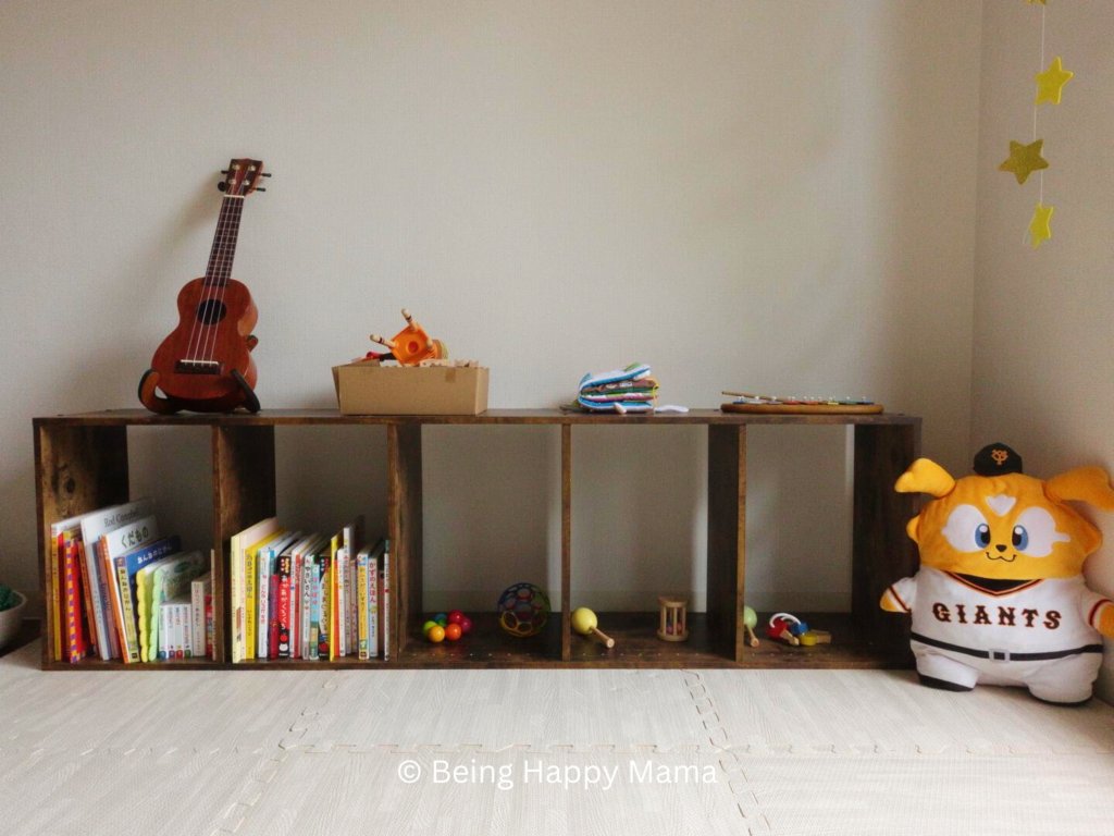 An image of an open-shelf Montessori setup featuring wooden shelves filled with various educational toys and materials. The shelves are organized neatly with toys, books, and manipulatives arranged at child-height, promoting easy access and independence. The background shows a bright, airy room with natural light.