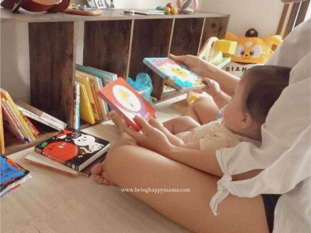 Baby selecting a book in a tidy Montessori playroom.