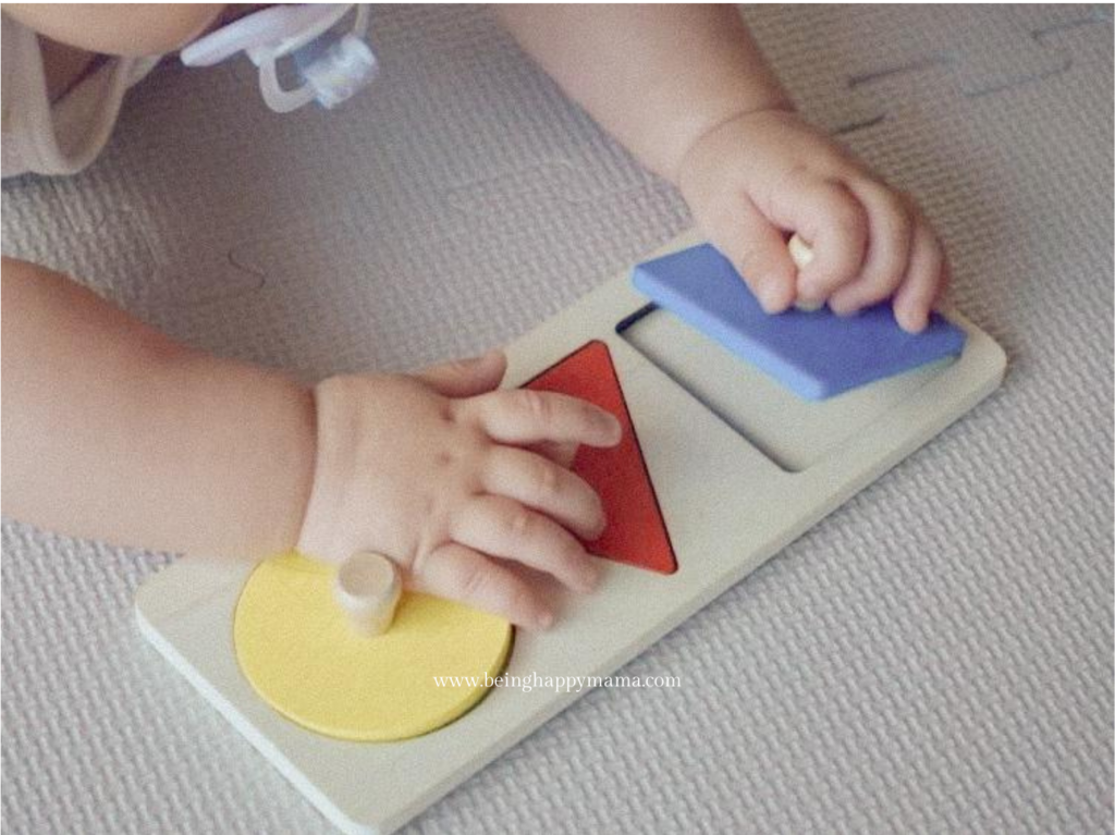 Baby is developing her pincer grasp by holding a puzzle piece.